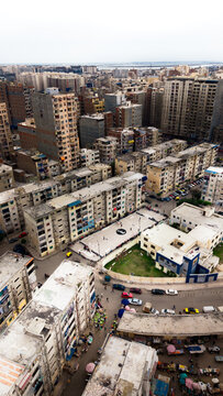 Aerial view of a Ramadan football tournament taking place on a street court surrounded by dense apartment buildings and urban infrastructure in Alexandria, Alexandria Governorate, Egypt.