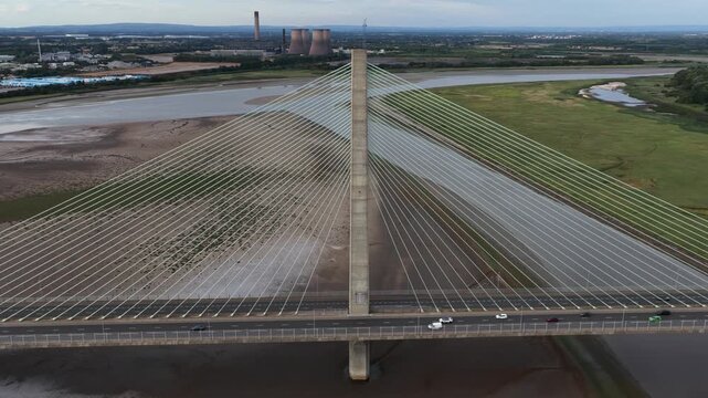Aerial view orbiting a modern cable stayed bridge over a river