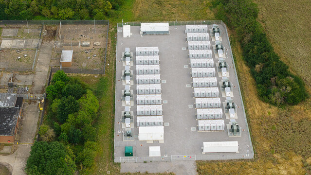 Aerial view of Battery storage BESS Sundon substation with rows of energy storage units and electrical infrastructure in a fenced compound in Chalton, England, United Kingdom.