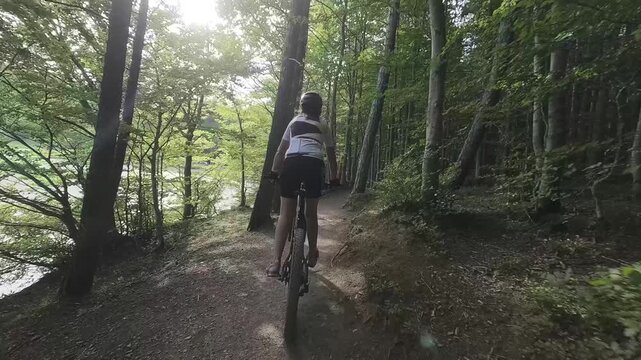 Donna bici MTB nella foresta e al lago Calamone