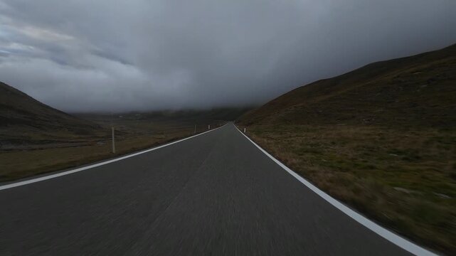 First person view of driving on a foggy mountain pass road