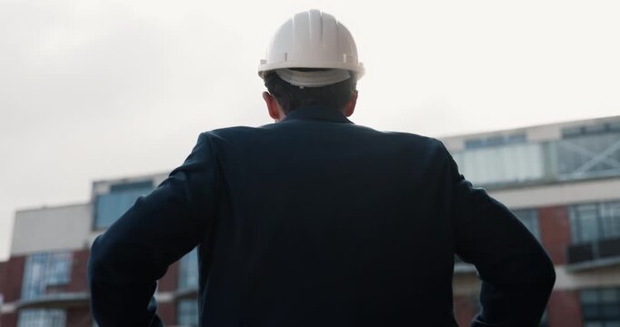 Back, helmet and engineer in city for construction safety, real estate development or thinking. Man, ppe and contractor outdoor for building inspection, compliance planning or property expansion