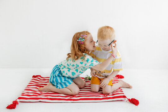 Kids play on blanket with simple designs