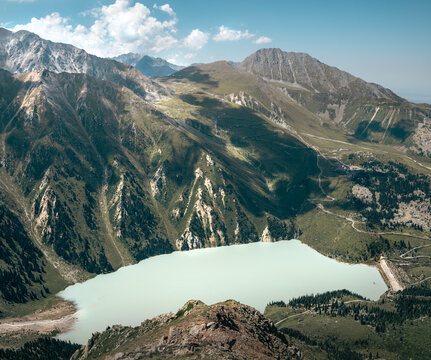 Turquoise Glacial Lake Surrounded by Rugged Alpine Mountains