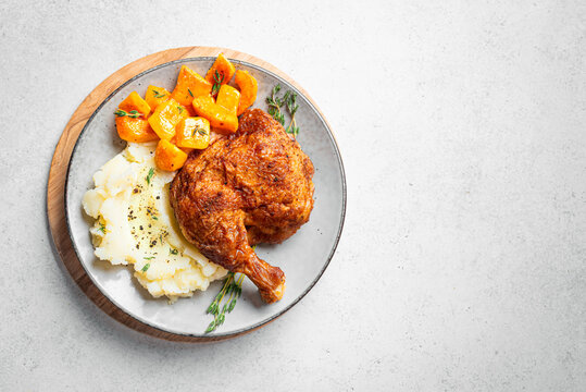 Autumn meal: chicken quarter with glazed pumpkin and mashed potato