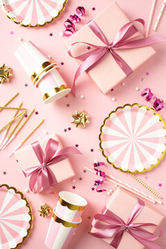 Pink party pattern with gift boxes and tableware top view