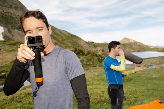 UGC Man filming with gopro camping setup with action camera