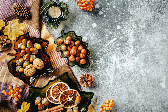 Autumn flat lay composition with nuts, spices and cozy blanket.