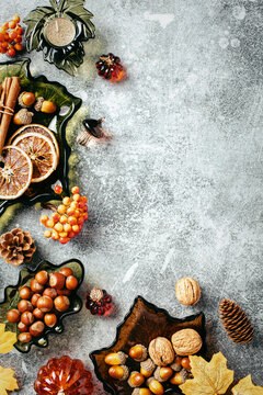Autumn vertical side border with nuts, spices and leaves.