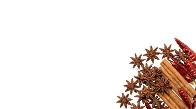 Star anise cinnamon sticks and red chili peppers arranged as a decorative border for culinary cooking background