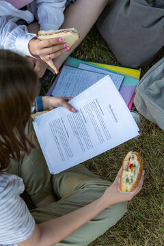 Students studying with sandwiches during outdoor study session