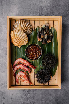 Assorted premium fresh raw seafood displayed in a wooden box