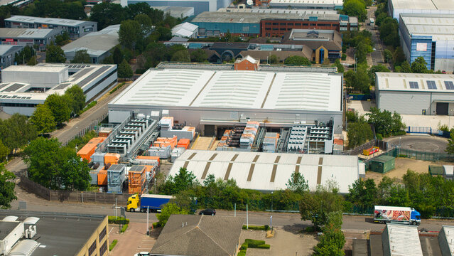 Aerial view of a data center facility featuring rows of external cooling units and industrial infrastructure in an urban business park in Hemel Hempstead, England, United Kingdom.