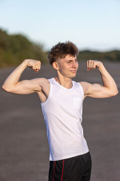 Teenage boy flexing his muscles