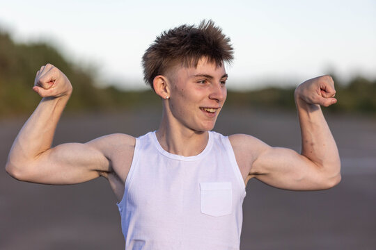 Teenage boy flexing his muscles