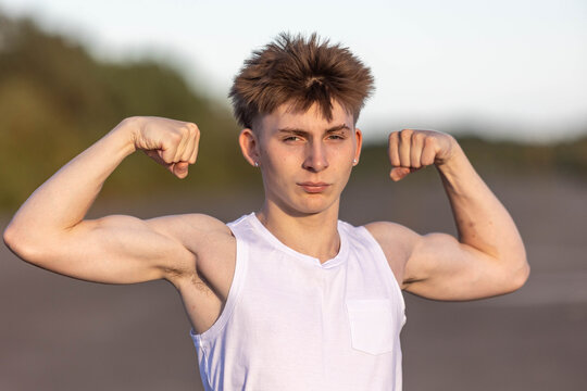 Teenage boy flexing his muscles