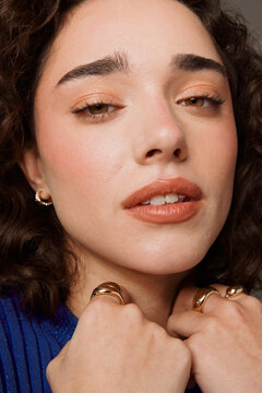 Model Poses for Close up With Jewelry and Soft Makeup Tones