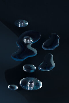 Close View of Face Serum Droplets on Dark Background with Copy Space