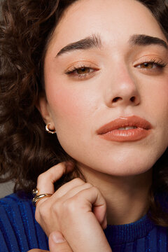 Woman Poses for a Close-Up Photo With a Neutral Expression