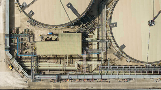 Aerial view of the petroleum oil terminal and LPG storage facility with complex pipe networks and large circular tanks in Hemel Hempstead, England, United Kingdom.