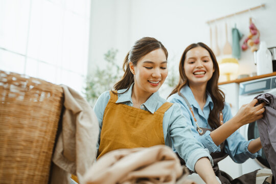 laundry clothes women with friendship folding; women clean laundry. laundry guides buyer choices, clothes frames the scene, and women adds useful meaning. Clear visual context supports stock buyers.