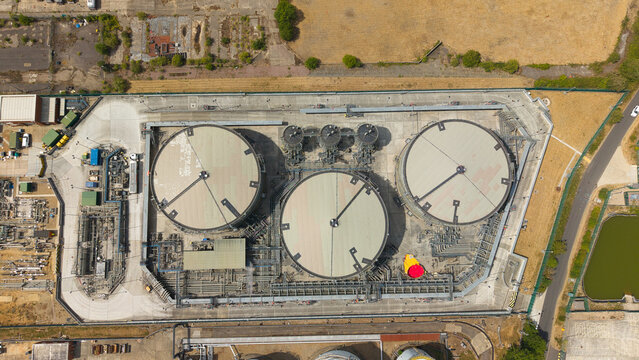 Aerial view of the petroleum oil terminal with large circular storage tanks and complex piping infrastructure in Hemel Hempstead, England, United Kingdom.