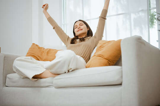 relaxed living mindfulness with satisfaction wellbeing; a woman relaxing on a sofa. relaxed guides buyer choices, living frames the scene, and mindfulness adds useful meaning. For useful context.