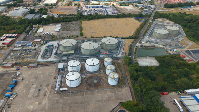 Aerial view of a petroleum oil terminal and LPG storage facility with large cylindrical tanks and industrial infrastructure in Hemel Hempstead, England, United Kingdom.