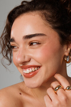 Model Smiles While Posing for a Beauty Shoot in Studio Setting