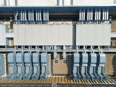 Aerial view of a hyperscale data center featuring rows of industrial air handling units and chillers installed on the roof in Hereford, England, United Kingdom.