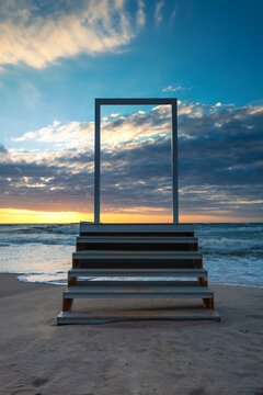 Open door and stairs access to the sea and sky. Concept image