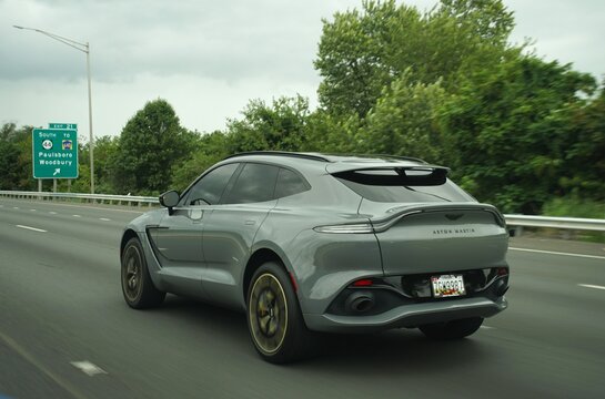Gloucester County, New Jersey, U.S.A - August 17, 2026 - A silver Aston Martin DBX driving on a highway, showcasing luxury SUV design and performance.