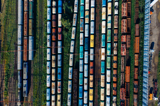 Aerial view of the Batumi Railway Station freight yard featuring rows of colorful cargo train cars parked on parallel tracks in Batumi, Adjara, Georgia.