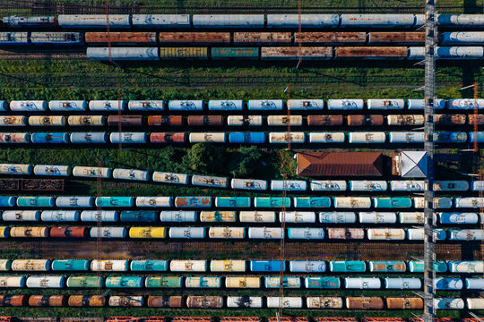 Aerial view of Batumi Railway Station freight yard with rows of colorful cargo train cars parked on parallel tracks in Batumi, Adjara, Georgia.