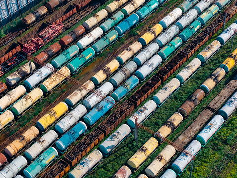 Aerial view of the freight yard at Batumi Railway Station with rows of colorful tank cars and cargo containers on parallel tracks in Batumi, Adjara, Georgia.