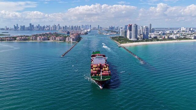 Miami, Florida, USA - September 11, 2025: Cargo ship Manzanillo Bridge with container. Freight container loaded on cargo vessel. Manzanillo Bridge cargo ship leaving harbor. Container ship.