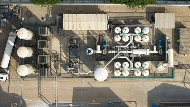 Aerial view of cryogenic storage tanks and gas vaporization systems at a glass manufacturing facility in Harlow, England, United Kingdom.