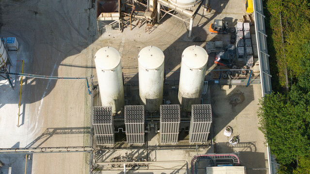 Aerial view of cryogenic storage tanks and gas vaporization systems at a glass manufacturing facility in Harlow, England, United Kingdom.