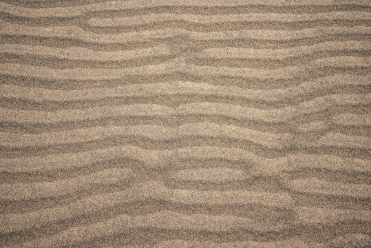 Clean gray sand on a beach as background