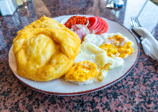 Macedonian breakfast plate serving Mekici and fried eggs