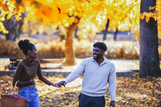Happy lovers walking in a quiet autumn woods