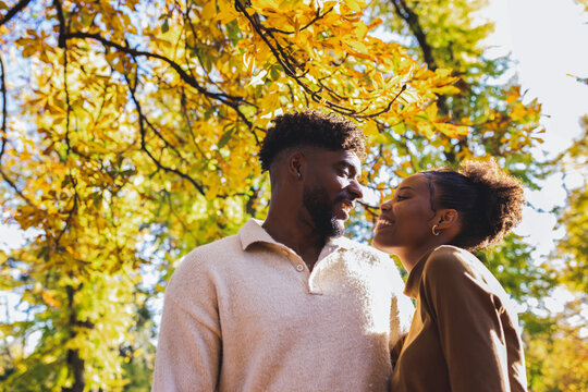 Warm embrace and sweet smiles in the fall park