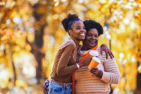 Close-up portrait of two generations smiling in autumn