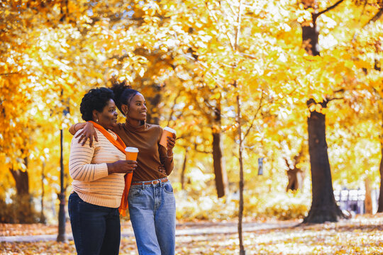 Happy family walk through a sun-drenched park