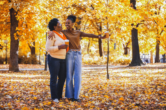 Playful family dance on a sunlit autumn path