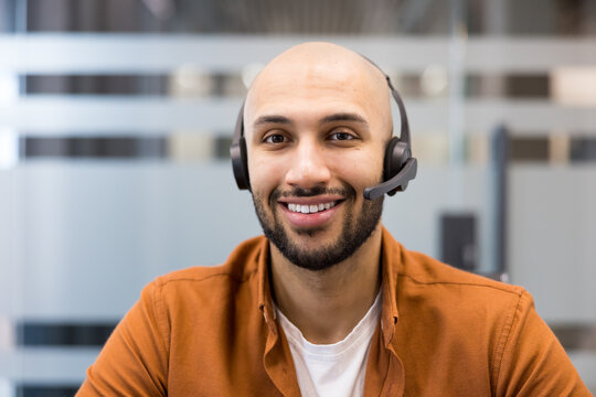 Smiling customer service agent wearing headset working in office