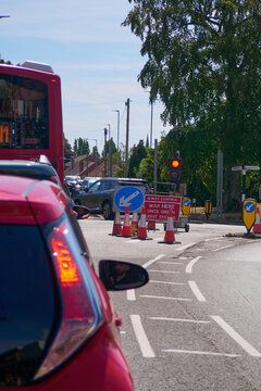 Road works, red light, traffic jam, red car and bus in a traffic jam.