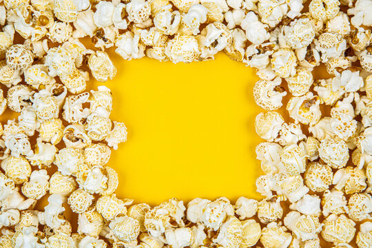 Tasty popcorn square frame yellow background