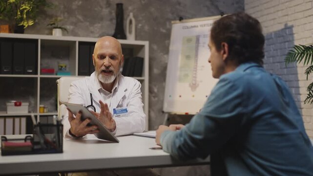 Endocrinologist shows medical test results to male patient, good prognosis