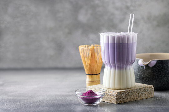 Ube latte in glass. Healthy vegan drink. Viral trendy asian beverage